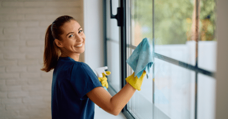 woman cleaning glass window