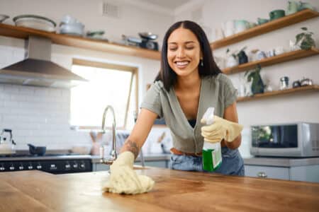 woman cleaning a kitchen counter